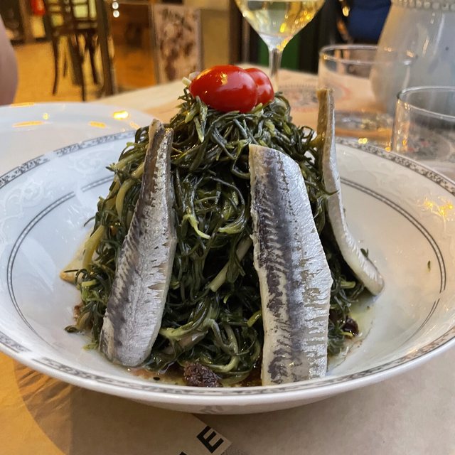 A whole fish over greens