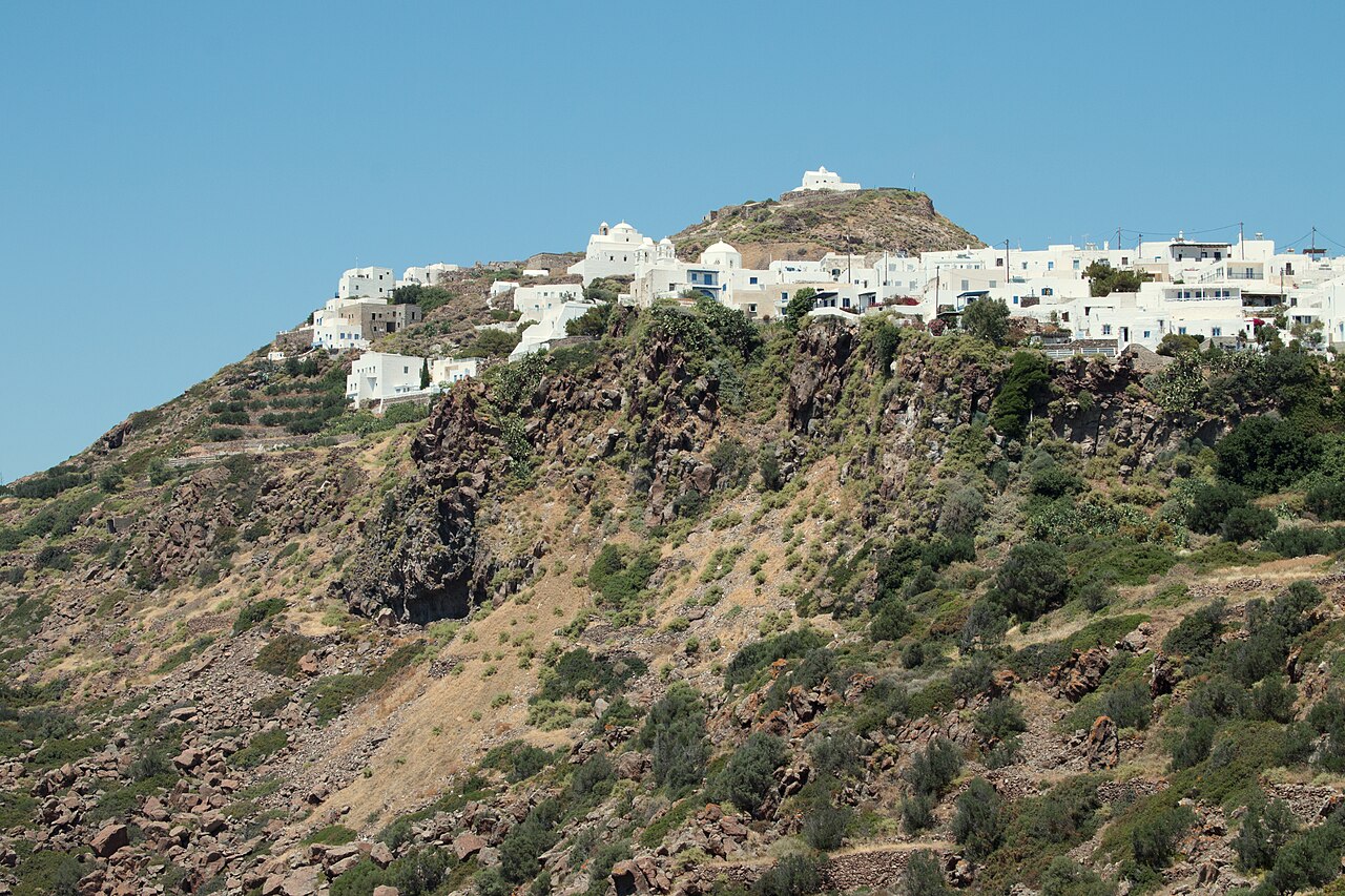 The hilltop town of Plaka on Milos, white houses on a volcanic crag with a chapel on the summit