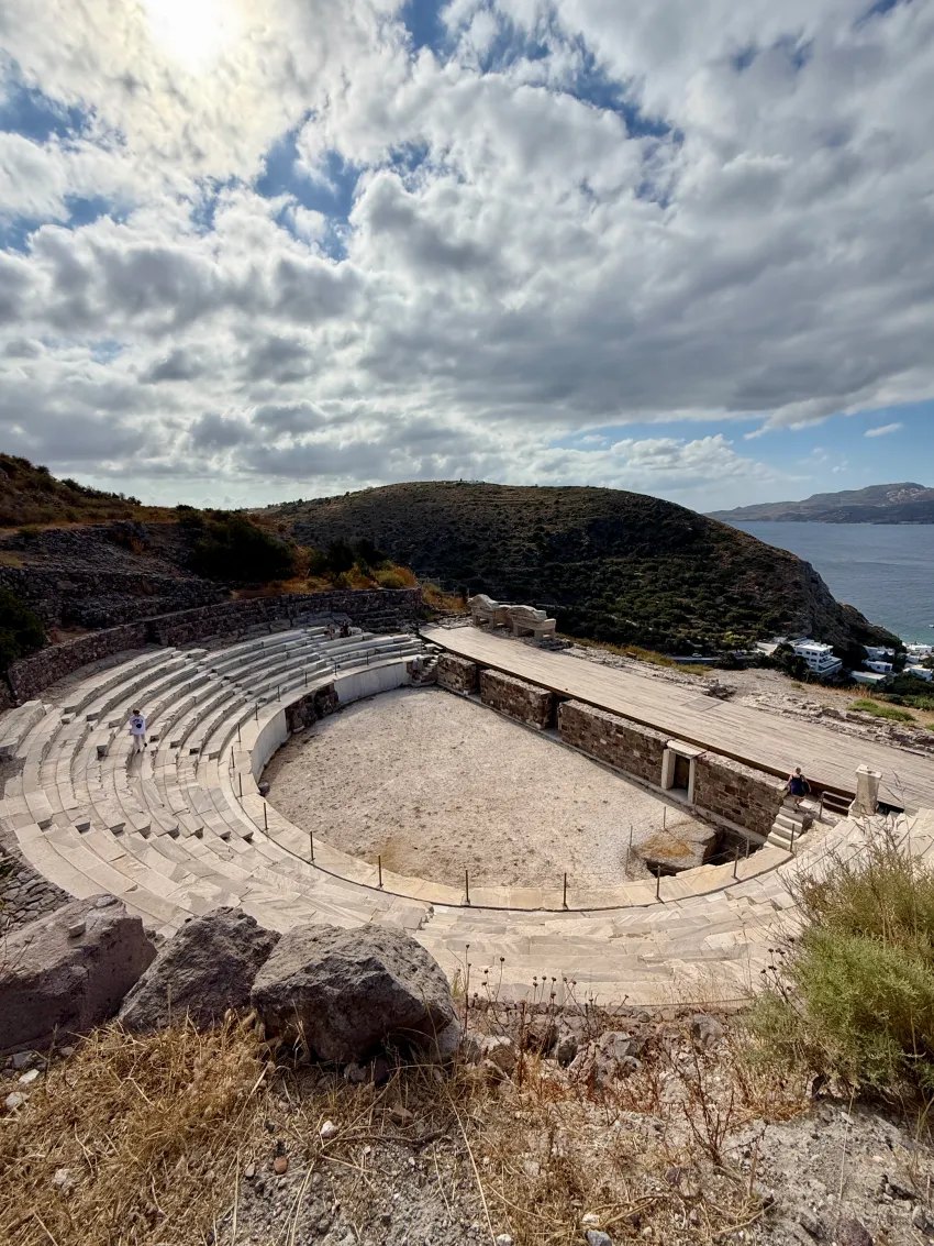 The ancient Roman theater of Milos cut into the hillside with the sea beyond