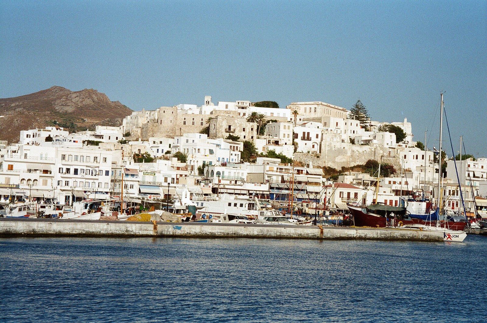 Naxos Chora and the Venetian Kastro seen from the harbor, fishing boats in front