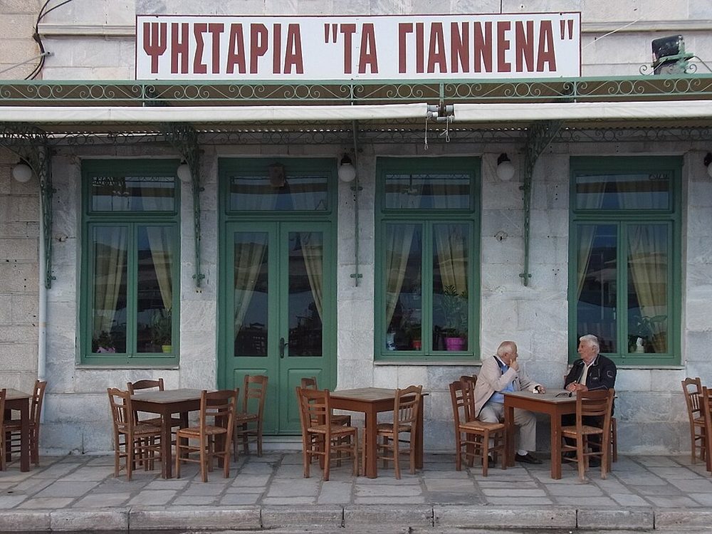 A harborside taverna in Ermoupoli with tables on the quay